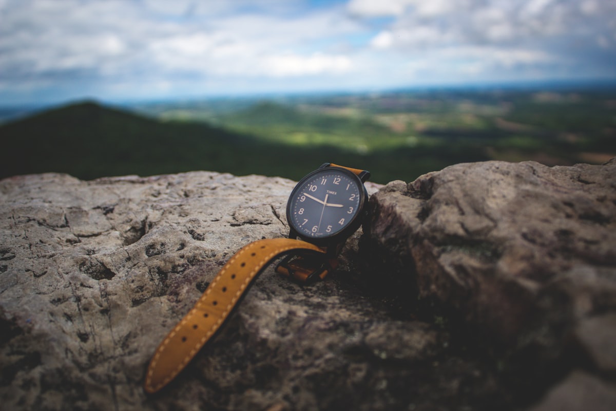 A fine wristwatch resting on a rock